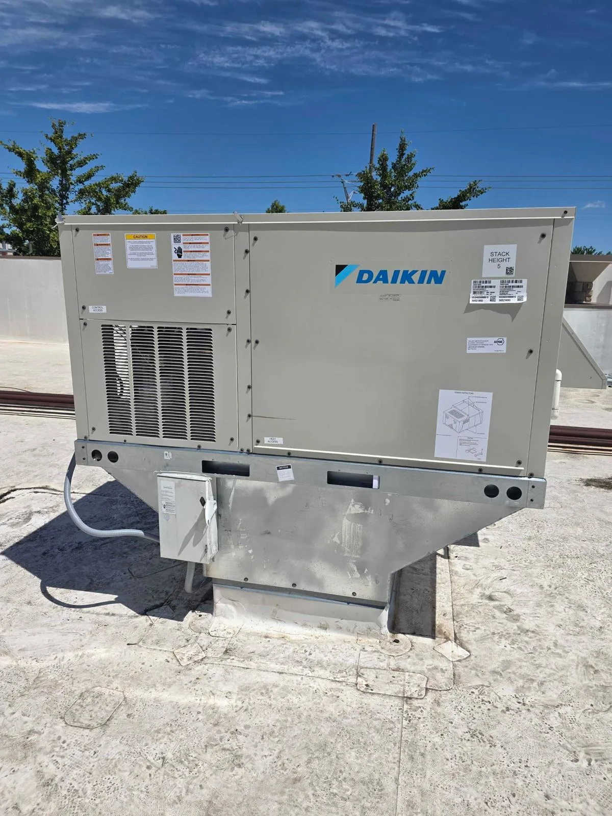 Daikin commercial rooftop package unit on metal curb adapter